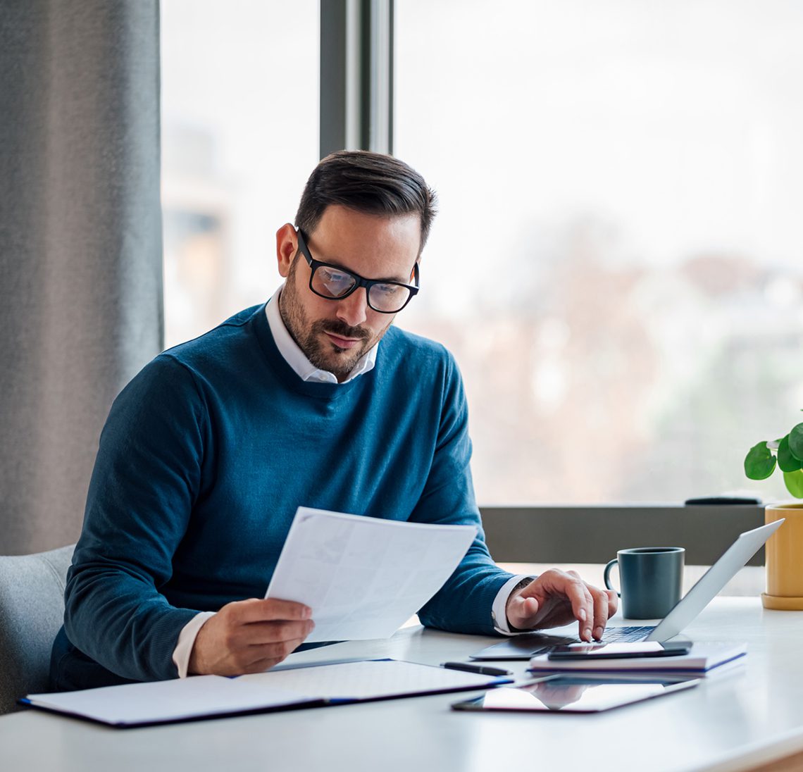 Businessman analyzing report indoors